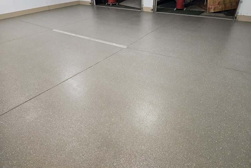 Wide-angle of Edina garage with mudstone flake polyurea floor