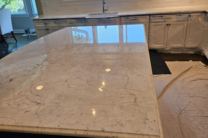 Restored natural stone kitchen countertop with full diamond polish and fresh impregnating sealer